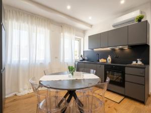 a kitchen with a table and chairs in a room at Sparano Mood 170 in Bari +12 photos