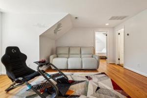 a living room with a white couch and a bike at Tog Gun R&R I in Norfolk