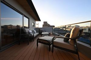 a balcony with couches and chairs on a roof at Kiyomizu Elite Terrace in Kyoto