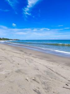 an empty beach with the ocean in the background at Casa los Pinos in Zorritos