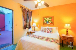 a bedroom with a bed and a ceiling fan at Beachside Bliss Suite 1 Block from Malecon in La Paz
