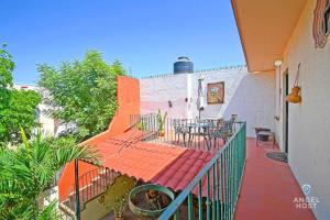 a balcony of a building with a table and chairs at Beachside Bliss Suite 1 Block from Malecon in La Paz