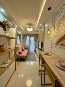 a living room with a couch and a table in a room at LuxeRN Suite at S Residences in Manila