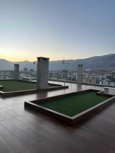 a view of a building with a field of grass at Departamento de lujo domotizado en la mejor zona de Cochabamba, frente al Paseo Aranjuez in Cochabamba
