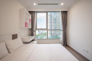 a bedroom with a white bed and a large window at Elysian Suites In Landmark Saigon by VNS in Ho Chi Minh City +153 photos