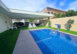 a swimming pool in the backyard of a house at Island Accommodation Suva Premier Hospitality in Suva