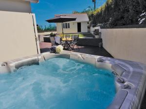 a hot tub in the backyard of a house at Four Seasons - Hw7432 in Tal-gareg