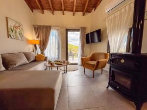 a living room with a couch and a table at Muses Mountain View in Ayía Varvára