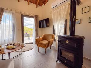 a living room with a wood stove and a table at Muses Mountain View in Ayía Varvára +38 photos