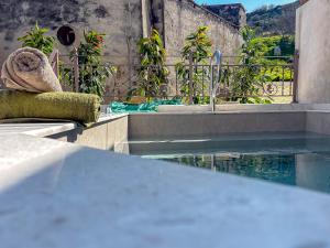 a swimming pool with a fountain and some plants at Muses Mountain View in Ayía Varvára