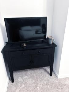 a black dresser with a flat screen tv on it at Saffire Villa Rooms in Tacoma