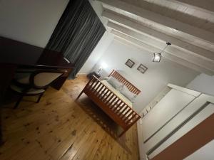 an overhead view of a room with a bench and a piano at Monica’s Apartments in Canning