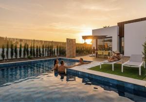 a group of people sitting in a swimming pool at Edelweiss in Los Alcázares