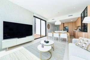 a living room with a large flat screen tv at Edelweiss in Los Alcázares