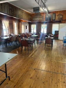 an empty restaurant with tables and chairs in a room at Walla Walla Hotel Motel in Walla-Walla