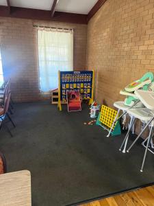 a room with tables and chairs in a brick wall at Walla Walla Hotel Motel in Walla-Walla