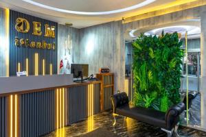 a lobby with a bar and a large plant at Dem İstanbul Airport Hotel in Istanbul