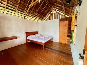 a bedroom with a bed in the middle of a room at Angelfish Guest House Raja Ampat in Besir +29 photos