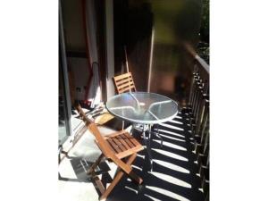 a glass table and two chairs on a balcony at Apartment Clos du Savoy in Chamonix-Mont-Blanc +15 photos
