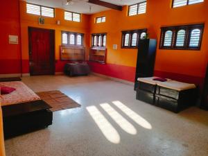 a large room with bright orange walls and windows at Untitled Space Residency in Bangalore +1 photo