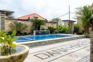 a swimming pool in the backyard of a house at Danas Pandawa Homestay in Nusa Dua