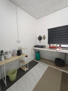 a room with white walls and a table and a shelf at Budget Rest House Padang Besar in Padang Besar +24 photos