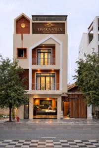 a building with a sign on the front of it at Osaka Villa Phan Thiet in Ấp Bình Hưng
