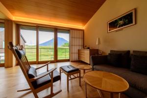 a living room with a couch and a table at NISEKO Inn of Youtei Raku Suisan in Kutchan