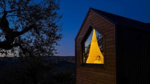 a person is looking out of a window of a house at Intermezzo X by Tiny Away in Citta' Sant'Angelo