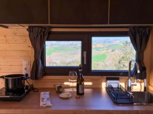 a kitchen counter with a sink and two windows at Intermezzo X by Tiny Away in Citta' Sant'Angelo