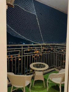a patio with chairs and a table on a balcony at Paradise Stays in Greater Noida