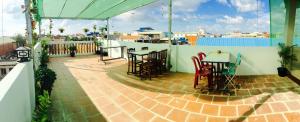 a patio with a table and chairs on a balcony at The Blue Guest House in Battambang