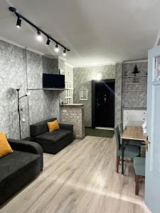 a living room with a couch and a table at Marina Apartments in Gudauri