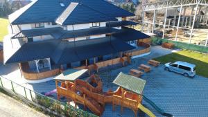 a model of a house with a pool with a playground at Vila Arina -Private Retreat in Voronet