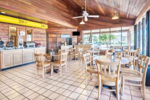 a restaurant with tables and chairs and a counter at Days Inn by Wyndham Spearfish in Spearfish