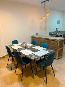 a table in a room with chairs and a counter at Kicker House in Puerto Baquerizo Moreno