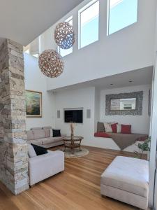 a living room with a couch and a fireplace at Luxury House steps from Mooloolaba Beach in Mooloolaba