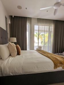 a bedroom with a large white bed with a window at Luxury House steps from Mooloolaba Beach in Mooloolaba +27 photos