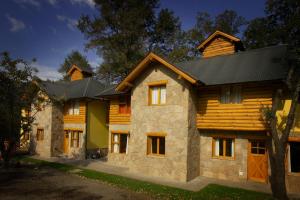 una casa de madera con techo negro en Apart Peumayen en San Martín de los Andes