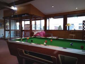 a living room with a pool table in a room at Appartements Les Balcons du Soleil in Font-Romeu