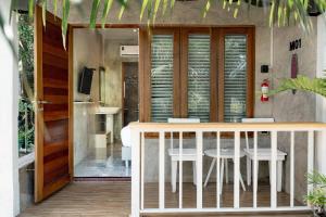 a balcony with a table and chairs in a room at Malai Maikhao Near Beach in Ban Mai Salae