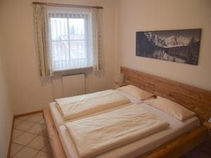 a bedroom with two beds and a window at Beautiful lodging in the Alps near Bayrischzell in Bayrischzell