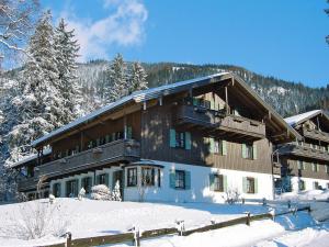 a large building with snow in front of it at Beautiful lodging in the Alps near Bayrischzell in Bayrischzell
