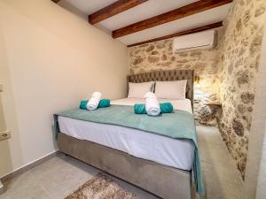 a bedroom with a bed with pillows on it at Muses Mountain View in Ayía Varvára