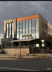 a hotel building with a sign on top of it at NEOS HOTEL in Astana