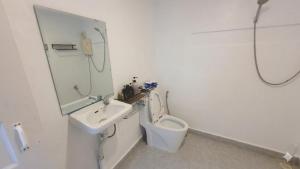 a white bathroom with a sink and a toilet at NISETH Home in Phumĭ Réach Born (2) +28 photos