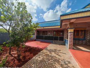 a house with a tree in front of it at ARMANI Villa Nagapattinam in Sikkil +5 photos