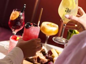 a group of people sitting at a table with drinks at Pullman Paris Centre - Bercy in Paris