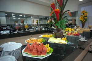 a buffet with several plates of food on a counter at Skala Traveling Hotel in Cuiabá