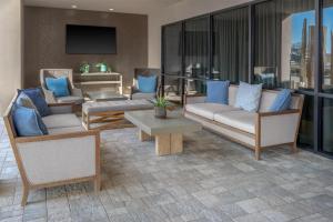 a living room with couches and blue pillows at Doubletree By Hilton Lubbock - University Area in Lubbock